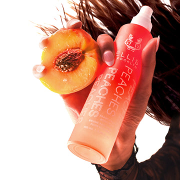 IMAGE 5: MODEL HOLDING PEACHES FRAGRANCE AND BODY MIST AND PEACH